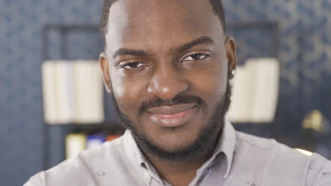 Close-up facial expression of black man. He is an office worker. 库存影片 228805348