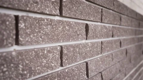 Close-up of facing bricks. Brown brick wall close up. Video stock 163423736