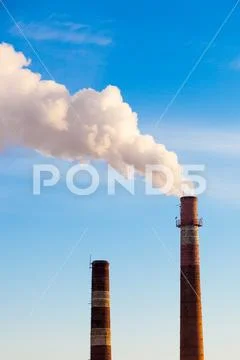 Close-up factory brick chimney. The smoke from the brick chimney cogenerati.. Stock Photos