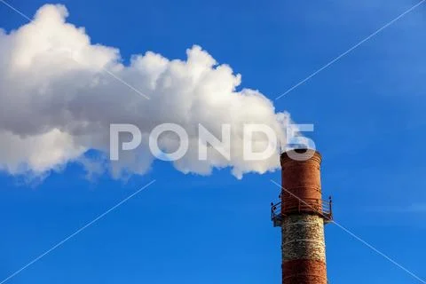 Close-up factory brick chimney. The smoke from the brick chimney cogenerati.. Stock Photos