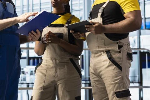 Close up of factory team doing problem solving to fix production bottleneck Stock Photos
