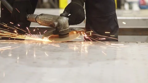 Close-up of factory worker hands in protective uniform, holding the metalworking Stock Footage 202049014