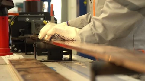 Close up of a factory worker pushing a piece of metal into a machine Stock Footage 160113836