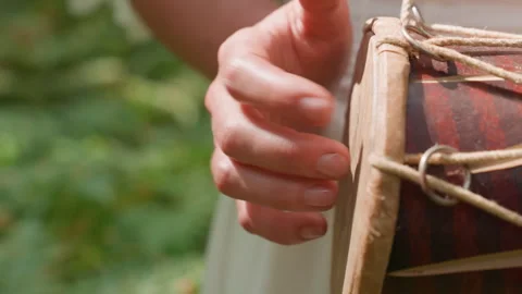 Close Up Of Fairy Person Tapping Drum Fast With Blur Forest Background Stock Footage 322902196