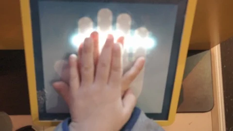 Close Up of Fake Palm Scanner Used by A Child's Hand Stockbeeldmateriaal 105835546