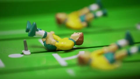 Close-up of fallen foosball players lying on the field after a goal. Stock Footage 321372057