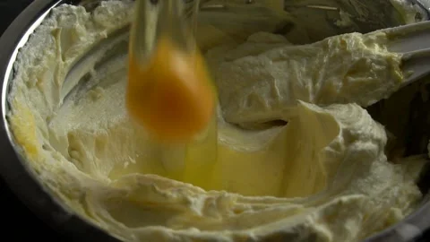 Close-up of falling chicken eggs in cottage cheese,butter cream. Stock Footage 141131595