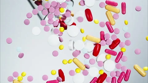 Close-up of falling coloured medicine tablets from glass on white background Stock Footage 157127806