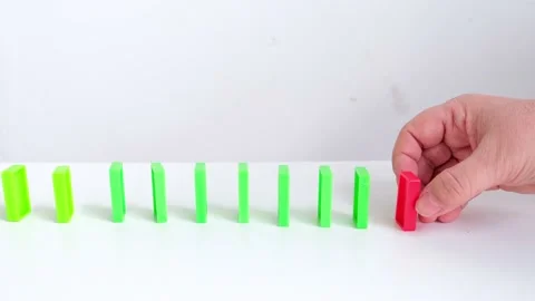 Close-up of falling crumbling dominoes. Line of colored domino cubes falling, Stock Footage 153622017
