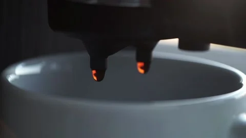 Close-up of falling drops of coffee into a white cup. Video stock 201291727