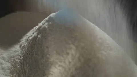 Close-up of falling flour forming a peak Stock-Footage 336046662