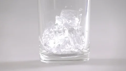 Close up of falling ice cubes into glass Stock Footage 103239826
