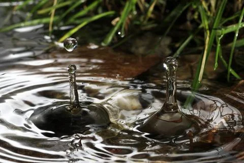 Close-up of a falling rain drop Stock Photos