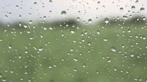 Close-up of falling rain drops on window glass Stock Footage 78090052