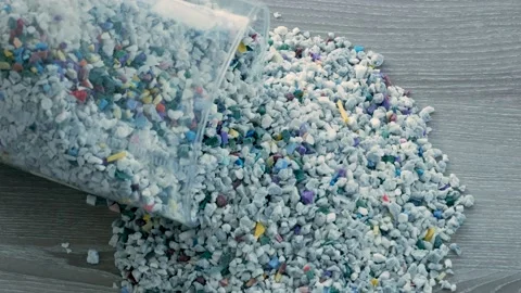 Close up of falling raw polypropylene granules for plastic industry. Stock Footage 233385852