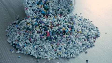 Close up of falling raw polypropylene granules for plastic industry. Stock Footage 233385892