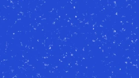 Close-up of falling snowflakes on blue background in slow motion Stock Footage 342022887