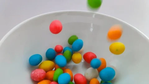 Close up on a falling sweets. Colorful sweet candy background. Slow motion Video stock 102500880