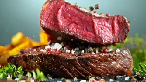 Close-up of falling tasty beef steak, slow motion. Stock Footage 129609487