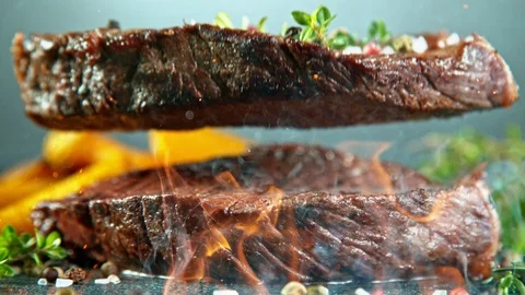 Close-up of falling tasty beef steak, slow motion. Stock Footage 129610569
