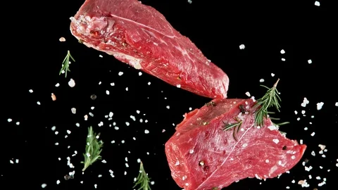 Close-up of falling tasty beef steak, slow motion. Stock Footage 129661846