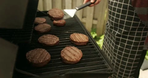 Close-up of falling tasty beef steak hamburg backyard Barbecue Stock Footage 336576306