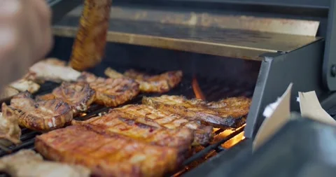 Close-up of falling tasty beef steak hamburg backyard Barbecue Stock Footage 336576432