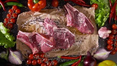Close-up of falling tasty beef steaks in kitchen, super slow motion. Organic Stock Footage 238511339