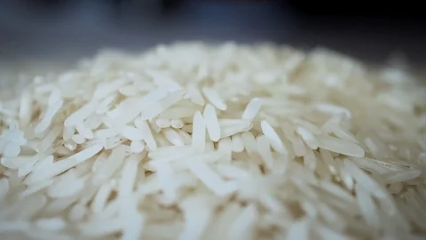 Close up falling white rice into a pile in slow motion Stock Footage 104712874