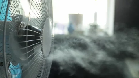 Close-up of a fan blowing mist and creating a cool, refreshing atmosphere Stock Footage 340265460