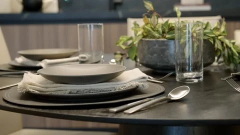 Close up of fancy round black dining table with elegant dinner tableware Stock-Footage 249491963