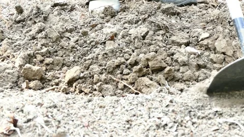 Close up farmer dig up the soil in garden Stock Footage 150564641