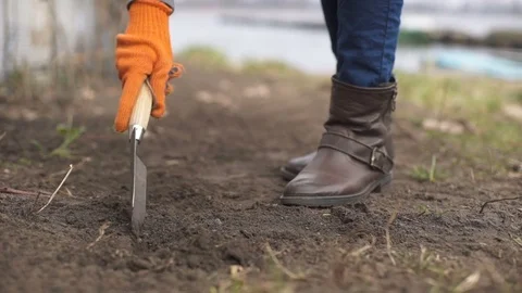 Close-up of a farmer's hand making grooves for planting a plant. slow motion Stock Footage
