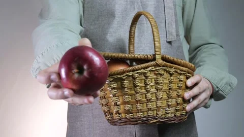 Close-up of a farmers hands holding a rustic woven basket filled with fresh red 스톡 동영상 315744548