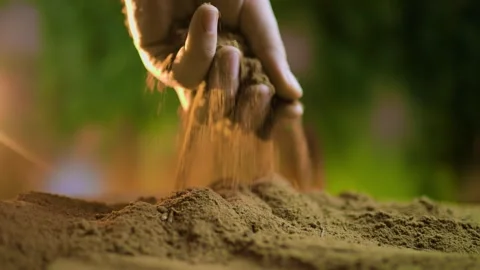 A close-up of a farmer's hands sifting through fertile soil with selective focus Stock Footage 267059820
