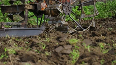 Close up farmers plow the fields using hand tractors Stock Footage 141984076