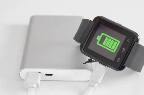 Close-up of  fast external battery that charges a discharged  wearable smartw Stock Photos