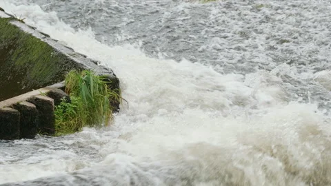 Close up of fast flowing river water converging at one point. 4K locked tripod Video stock 141378016