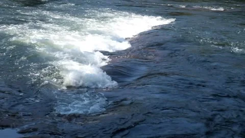 Close up of fast flowing river water Stock Footage 328444565