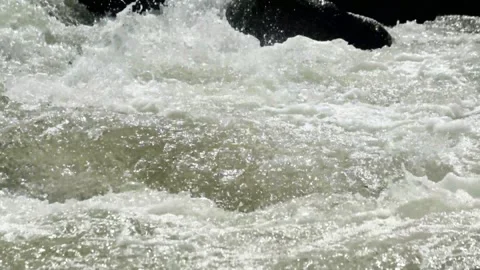 Close up of a fast flowing rocky mountain river Stock Footage 320954411