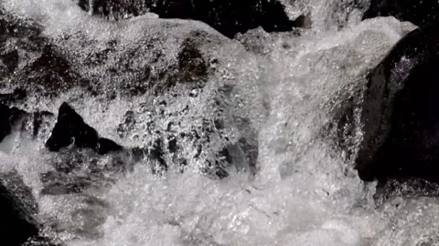 Close up of a fast flowing stream in a rocky mountain waterfall Stock Footage 320983480