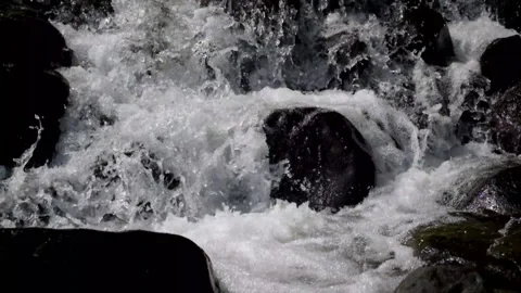 Close up of a fast flowing stream in a rocky mountain waterfall Stock Footage 320983600