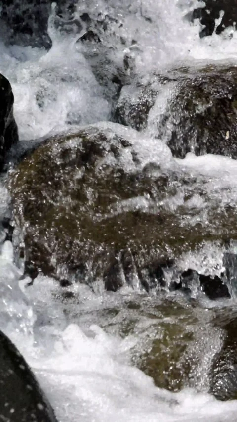 Close up of a fast flowing stream in a rocky mountain waterfall Stock Footage 320983641