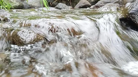 Close-Up of Fast Flowing Stream Water Over Rocks – Nature Detail Stock Footage 330560548