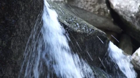 Close up: Fast flowing water on large rock at Lower Yosemite Falls Stock Footage 241194064