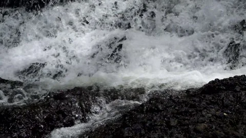 Close up of fast flowing waterfall in the mountains Stock Footage 297632843