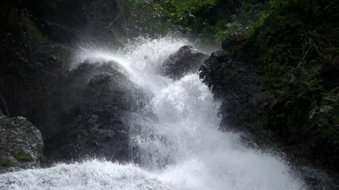 Close up of fast flowing waterfall in the mountains Stock Footage 297633500