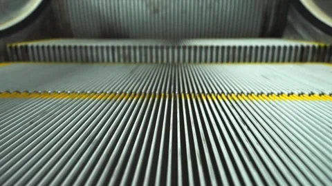 Close up of the fast moving down empty escalator steps with grooves. Stock Footage 255053447