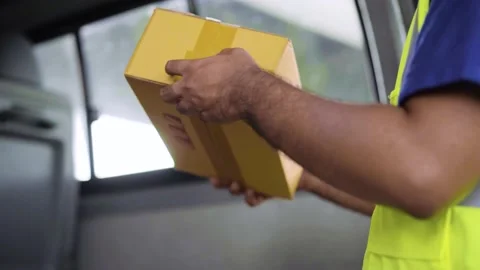 Close Up. Fast post shipment service concept. Young asian deliveryman wear blue  Stock Footage 137630481