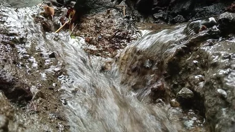 Close Up of Fast Water Flowing Over Rocks in Stream Stock Footage 329783786